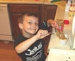 Timothy is scooping out peanut butter for one of his 4-H projects.