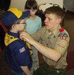 Uncle Bruce is helping Timothy with his uniform :)